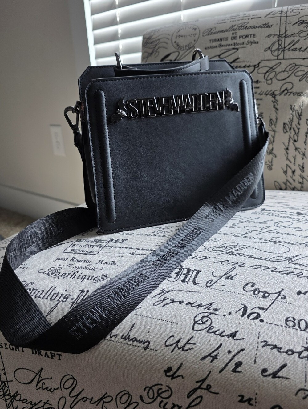 Steve Madden Bevelyn Crossbody Bag – Black with Bat Logo Detail